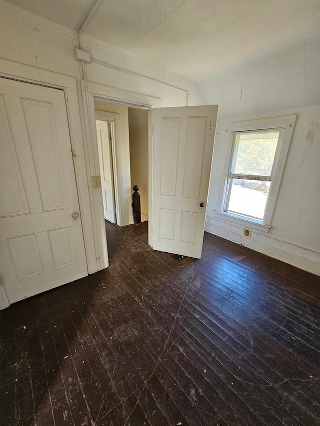 unfurnished bedroom featuring dark hardwood / wood-style flooring