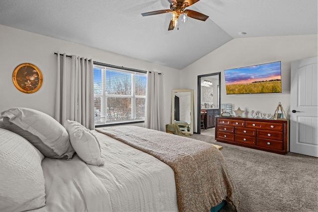 bedroom featuring carpet floors, connected bathroom, a ceiling fan, and lofted ceiling