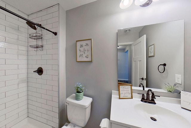 bathroom featuring vanity, a shower stall, and toilet