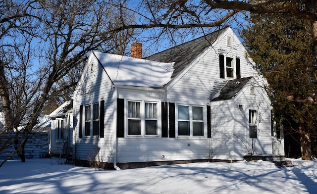 cape cod-style house with a chimney