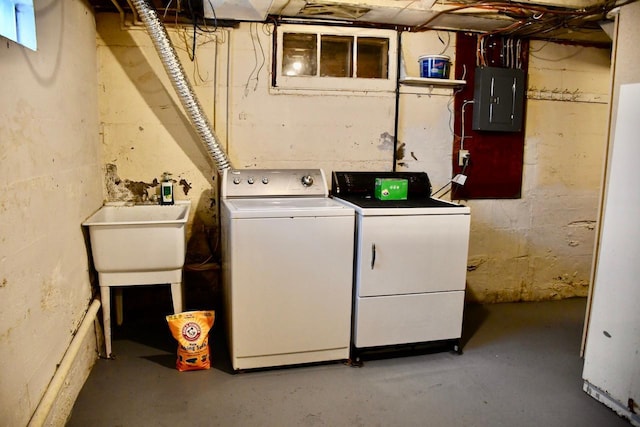 laundry room with laundry area, electric panel, and washer and clothes dryer