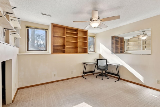 office area featuring visible vents, baseboards, and a textured ceiling