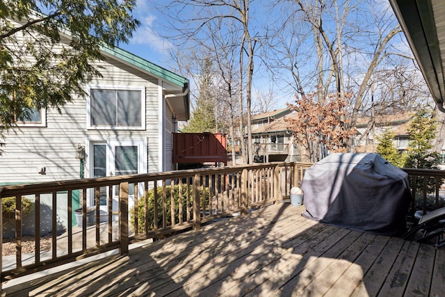 wooden deck featuring a grill