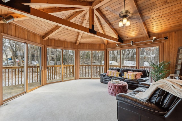 carpeted living room with ceiling fan, wooden walls, lofted ceiling with beams, and wood ceiling