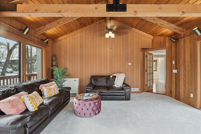 carpeted living room with radiator, wooden ceiling, wood walls, and beam ceiling