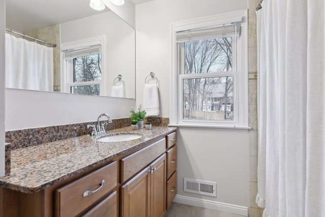 bathroom with tile patterned floors and vanity