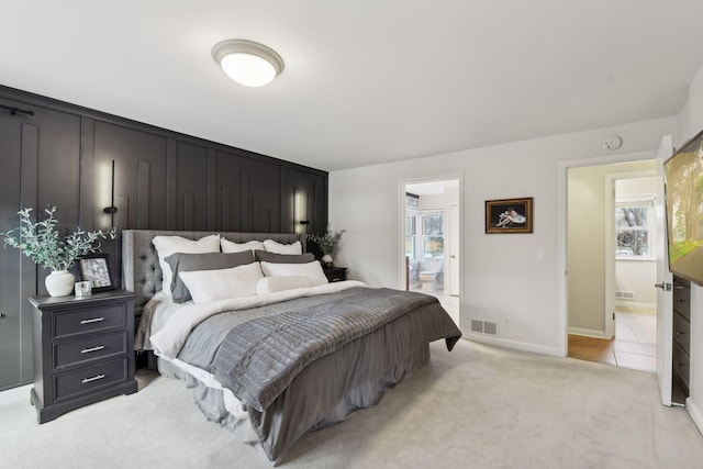 carpeted bedroom featuring connected bathroom