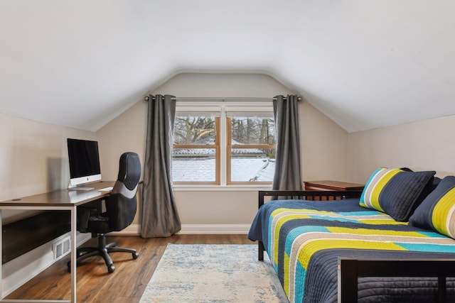 bedroom featuring wood-type flooring and lofted ceiling