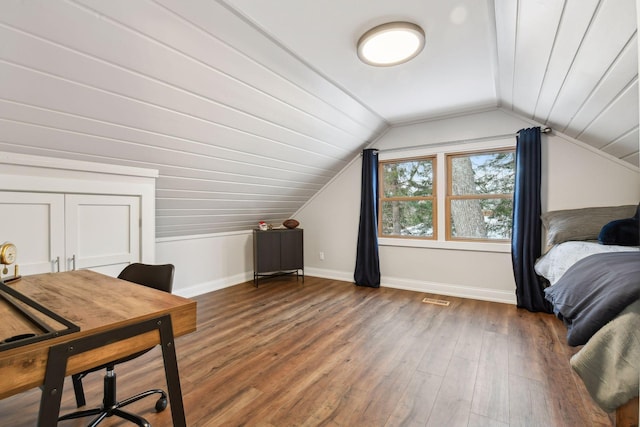 bedroom featuring lofted ceiling and dark wood-type flooring