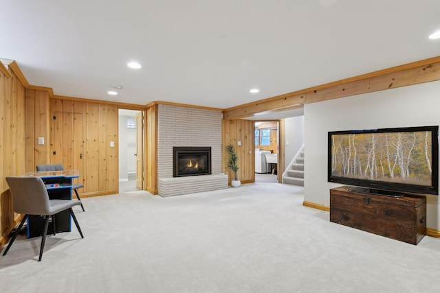 living room featuring light carpet, wood walls, and a fireplace