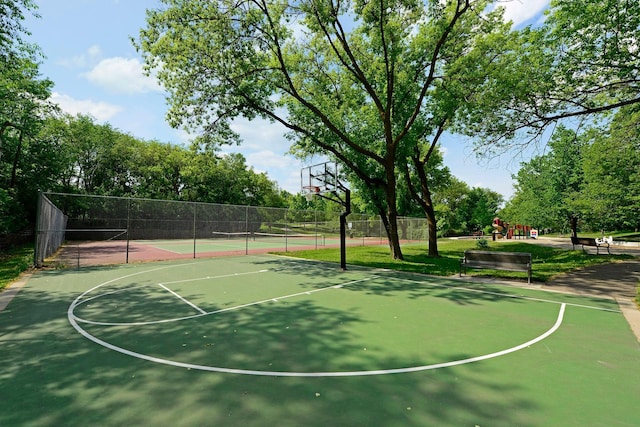 view of basketball court featuring tennis court and a playground