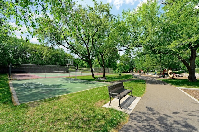 view of community featuring a playground, tennis court, basketball hoop, and a yard