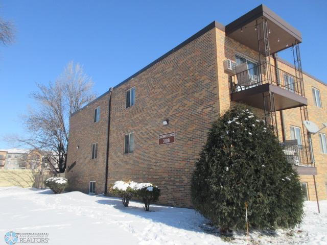 snow covered property featuring a balcony