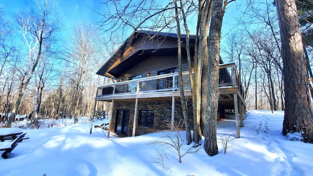 exterior space featuring a balcony and stone siding