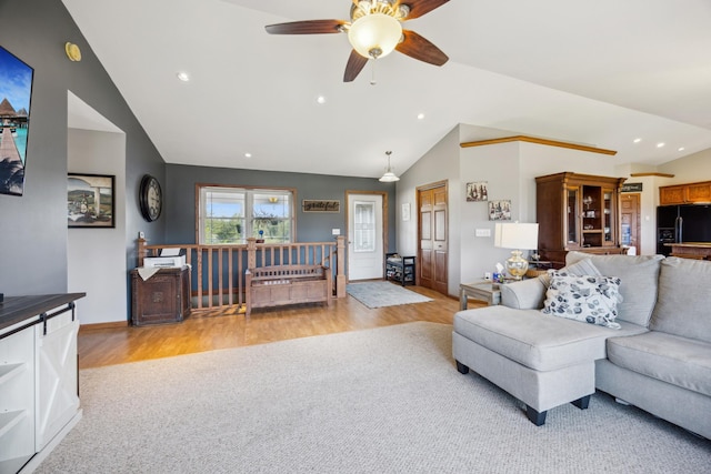 living room with lofted ceiling, light wood-style flooring, and recessed lighting