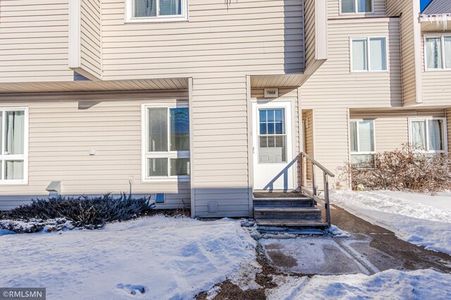 view of snow covered property entrance