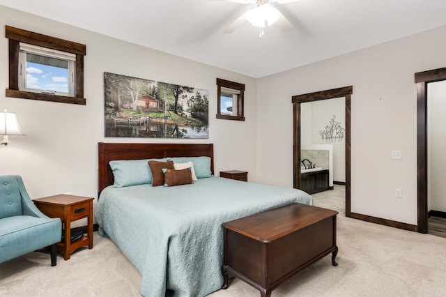 carpeted bedroom with ceiling fan and ensuite bath