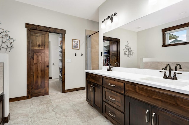 bathroom featuring vanity, tiled shower, and tile patterned floors