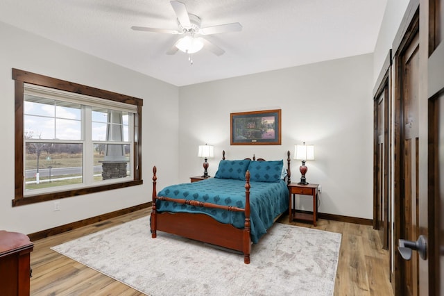 bedroom with ceiling fan and wood-type flooring