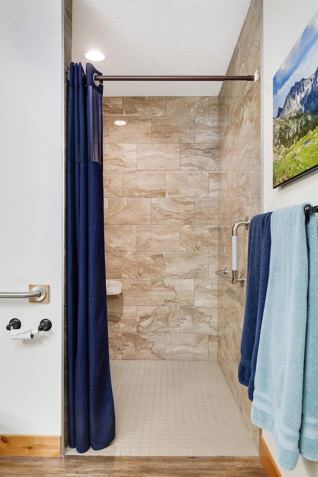 bathroom featuring curtained shower and a textured ceiling