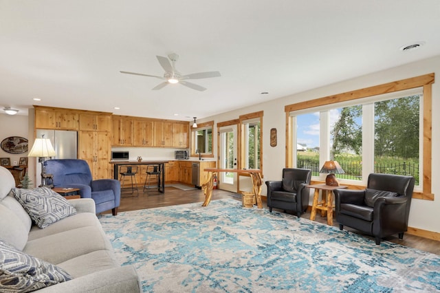 living room with hardwood / wood-style floors and ceiling fan