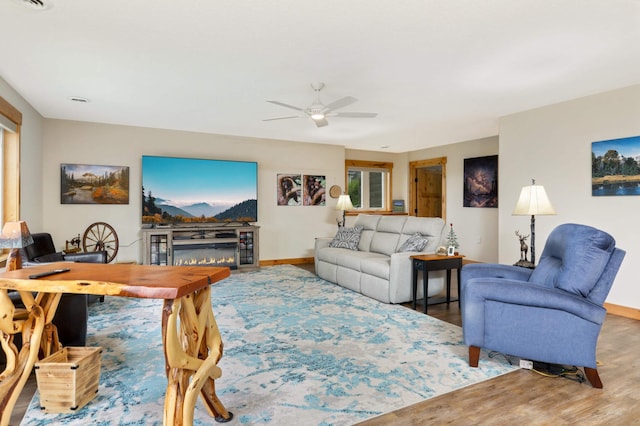 living room with ceiling fan and wood-type flooring