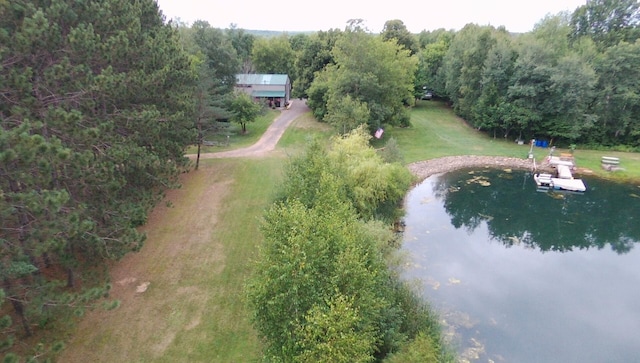 drone / aerial view featuring a water view and a forest view