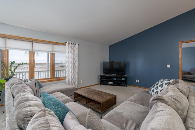 carpeted living room featuring lofted ceiling