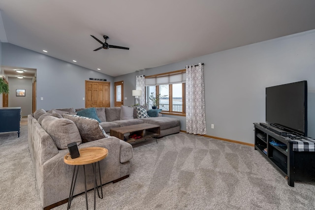 carpeted living room with lofted ceiling and ceiling fan