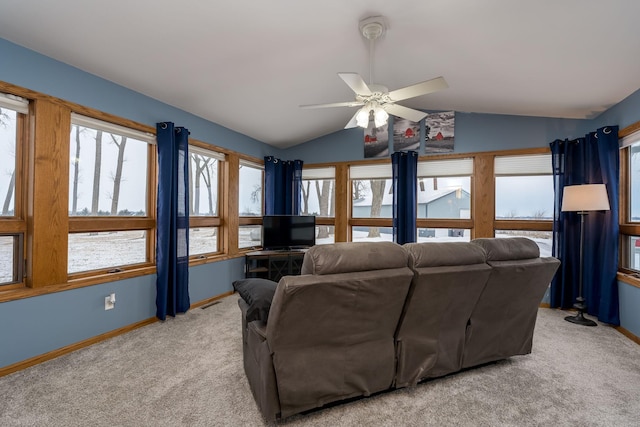 living room featuring lofted ceiling, ceiling fan, and light colored carpet