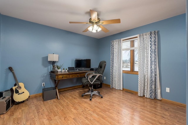 office with ceiling fan and light hardwood / wood-style flooring