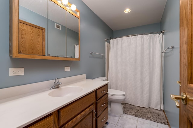 bathroom with tile patterned floors, toilet, vanity, and a shower with curtain