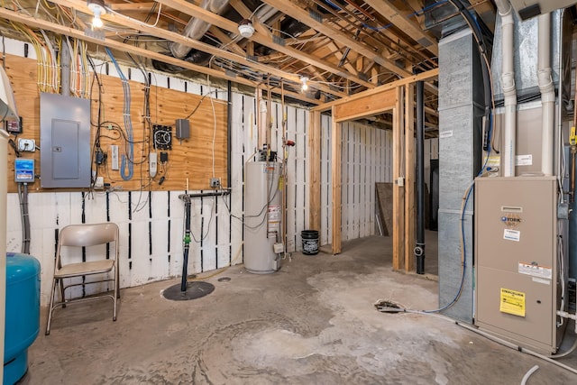 basement with electric panel, water heater, and heating unit