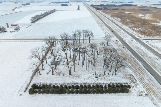 snowy aerial view featuring a rural view