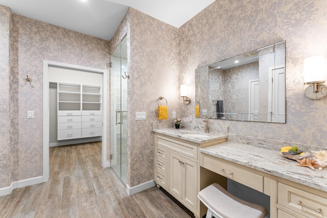 bathroom featuring a shower with door, hardwood / wood-style flooring, and vanity