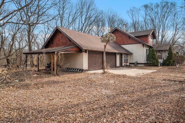 view of property exterior featuring driveway and an attached garage