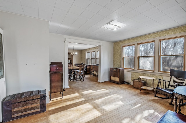 sitting room featuring a notable chandelier and hardwood / wood-style floors