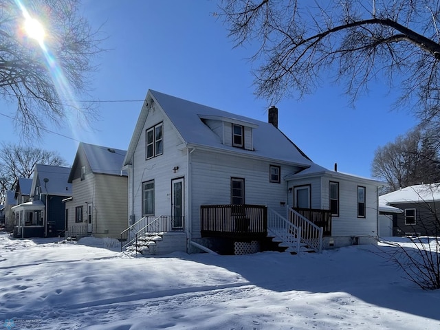 view of front of house featuring a chimney