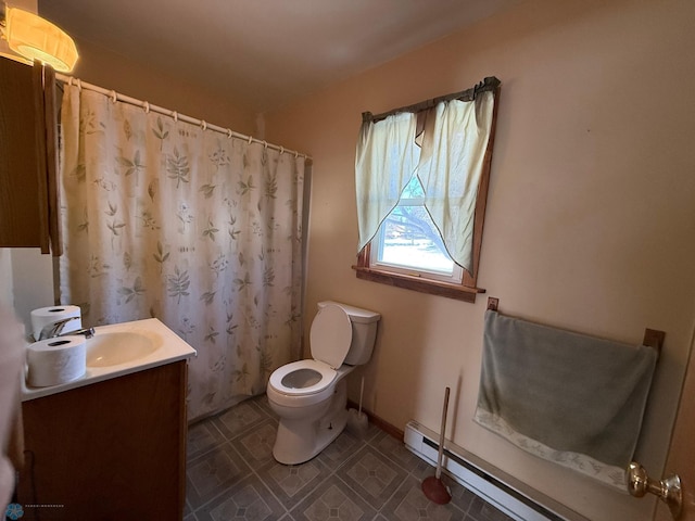 bathroom featuring toilet, vanity, and baseboard heating