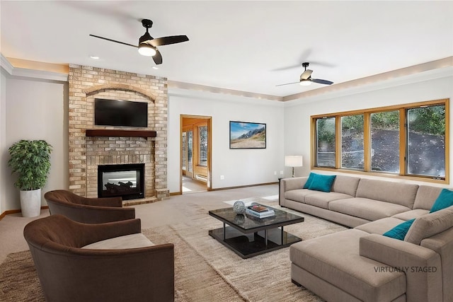 living room with a fireplace, ceiling fan, and carpet flooring