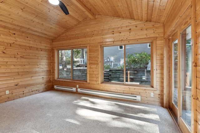 spare room with lofted ceiling, carpet flooring, wood walls, and baseboard heating