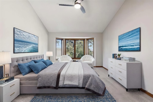 bedroom featuring ceiling fan, vaulted ceiling, and light colored carpet