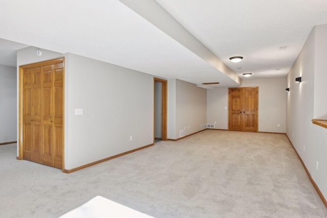 basement featuring light carpet