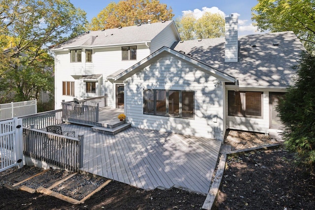 rear view of house with a wooden deck