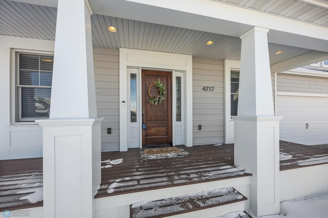 view of exterior entry with a garage