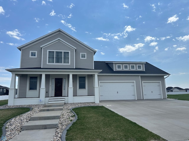 4717 11th St W, West Fargo, ND 58078 - view of front facade featuring driveway, covered porch, an attached garage, a shingled roof, and a front lawn