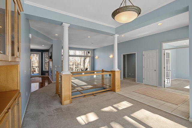 interior space featuring light carpet, recessed lighting, crown molding, and decorative columns