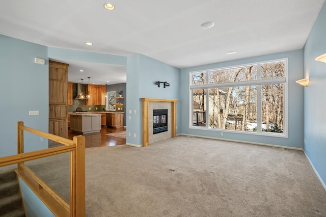 living area with baseboards, stairs, carpet floors, recessed lighting, and a fireplace