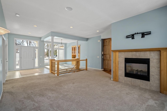 unfurnished living room featuring tile patterned flooring, carpet, vaulted ceiling, recessed lighting, and a fireplace