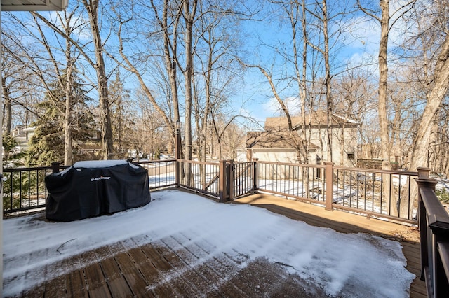 snow covered deck with an outbuilding and area for grilling